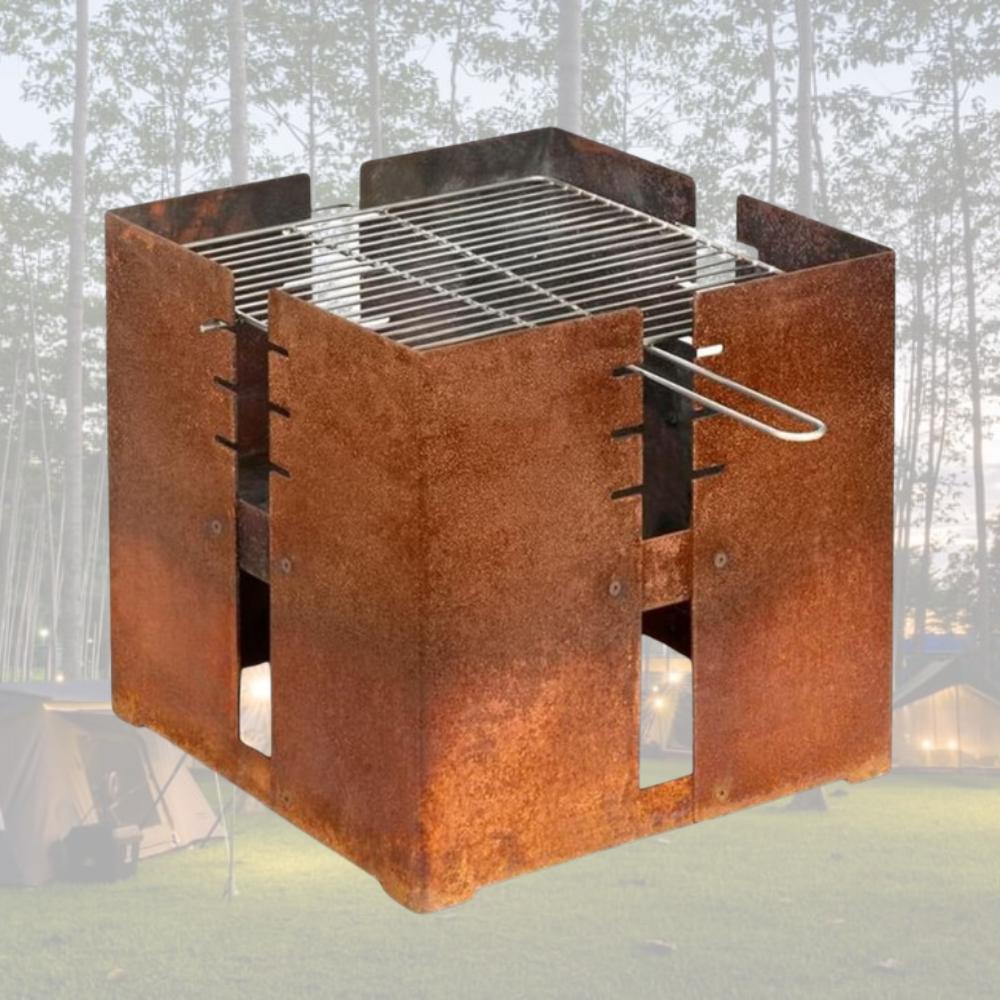 A corten steel fire pit and grill lit in the evening